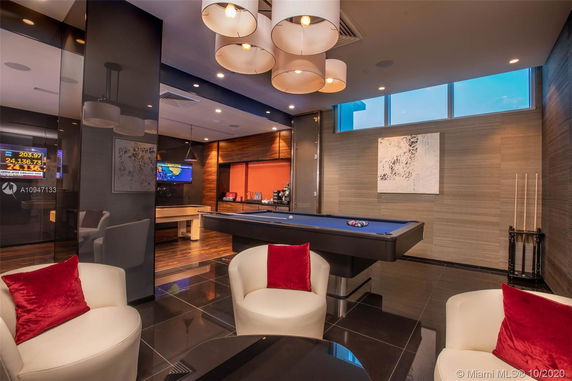 Room with pool table and seating area.