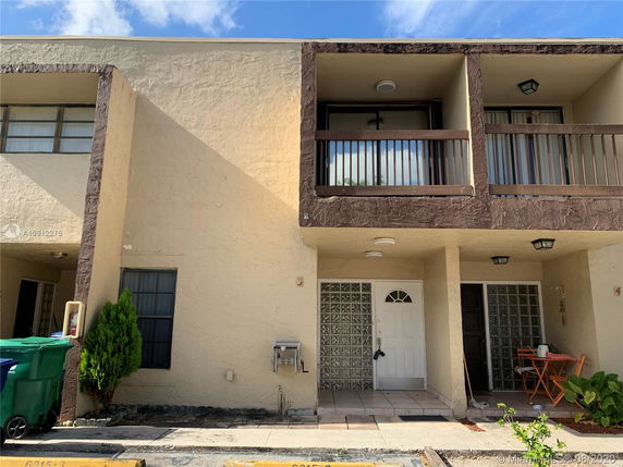 Front view of a two-story townhouse with balconies.