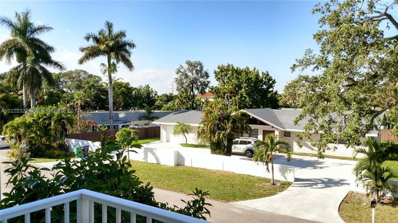 View from a building of a residential area with palm trees.