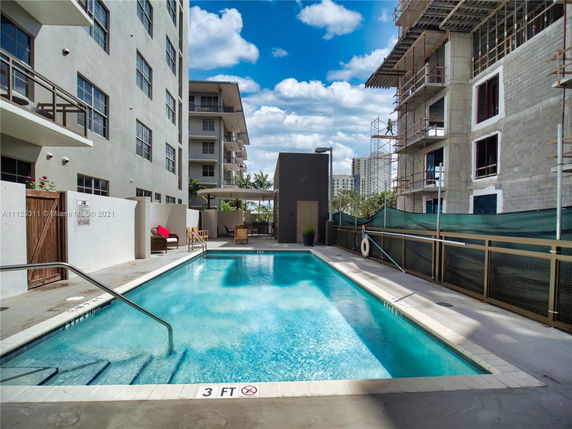 Outdoor swimming pool area between buildings
