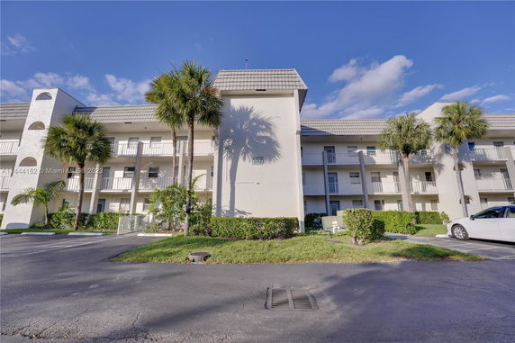 Front view of a multi-story residential building with balconies.
