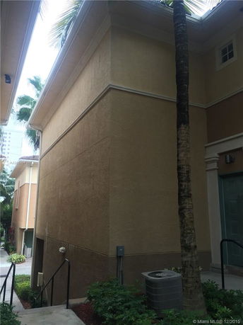 Side view of a multi-story building with a beige exterior.