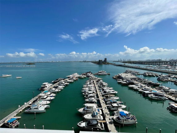 View of a marina with multiple boats docked in a body of water.