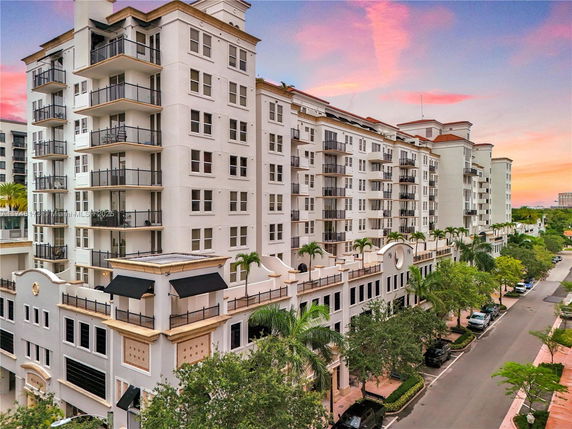 Front view of a multi-story apartment building with balconies.