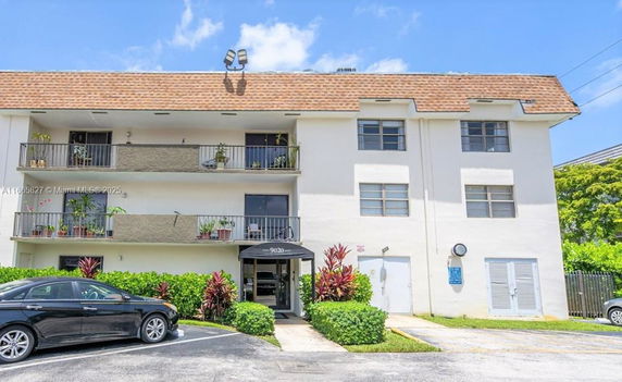Front view of a multi-story residential building with balconies.