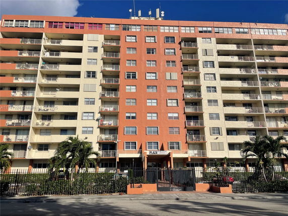 Front view of a multi-story apartment building with balconies.