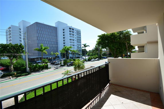 View of surrounding multi-story buildings and street from a balcony.