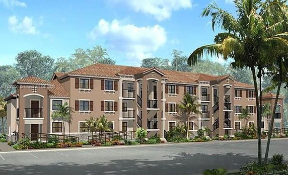 Front view of a three-story apartment building with balconies and palm trees.