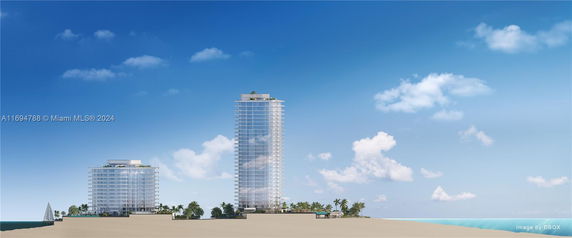 Front view of two modern high-rise buildings near the beach.