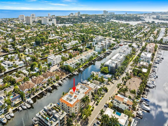 Panoramic aerial view of a coastal city with waterways and residential buildings.