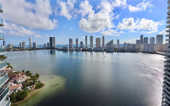 Panoramic view of city skyline and water body.