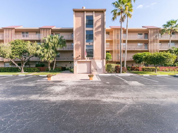 Front view of a multi-story residential building with balconies.