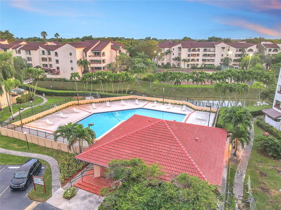 Aerial view of a swimming pool with surrounding residential buildings.
