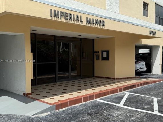 Front view of a building entrance labeled Imperial Manor.