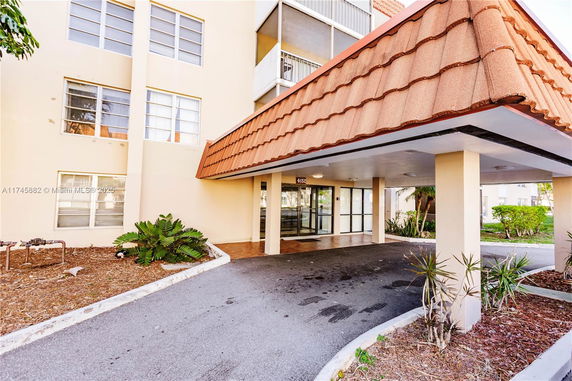 Front view of a building with a covered entrance.