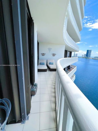 Balcony with a view of the ocean and city skyline