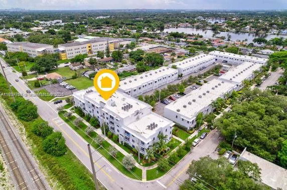 Aerial view of a residential complex with multiple buildings in an urban area.