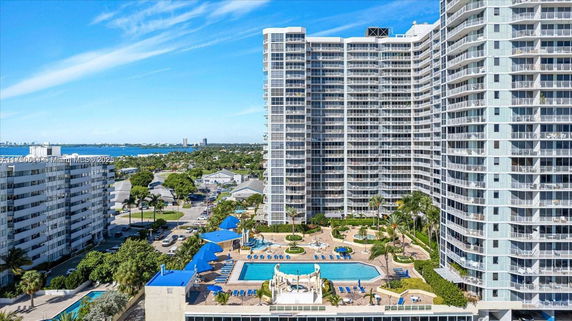 Front view of high-rise buildings with a swimming pool in the courtyard area.