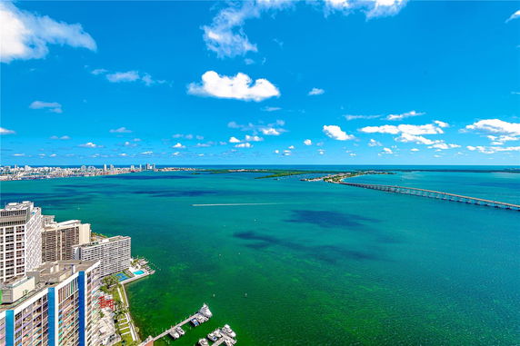 Panoramic view of a cityscape and ocean with a bridge crossing over the water.