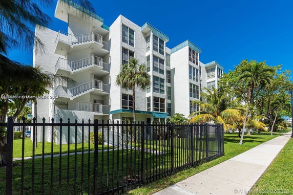 Front view of a multi-story apartment building with balconies.
