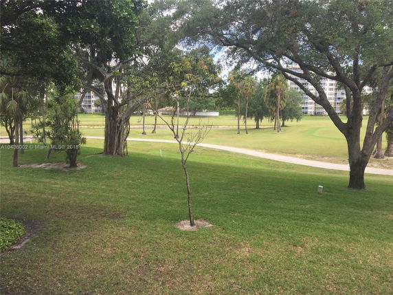 View of buildings and landscaped greenery in an outdoor area.