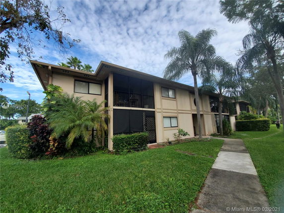 Front view of a two-story residential building with balconies.