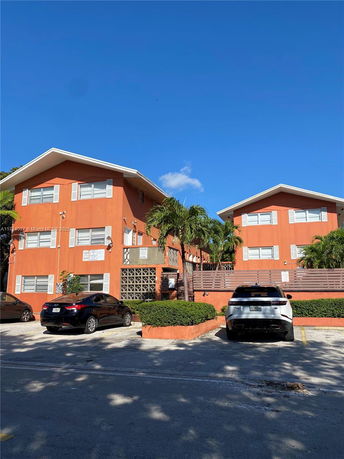 Front view of a two-story apartment building with parking in front.