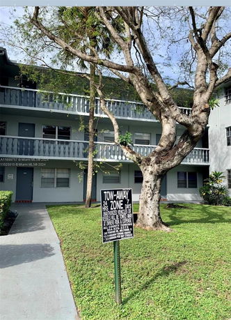 Front view of a multi-story apartment building with balconies.