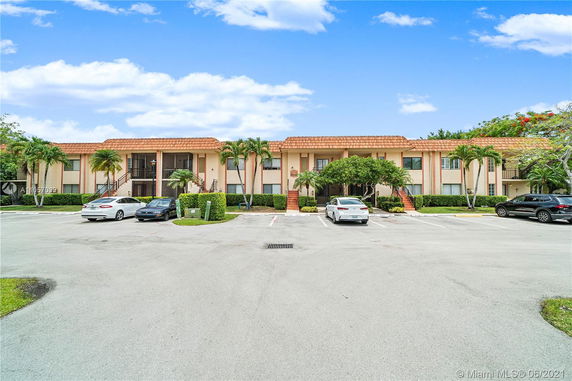 Front view of a building with outdoor parking area.