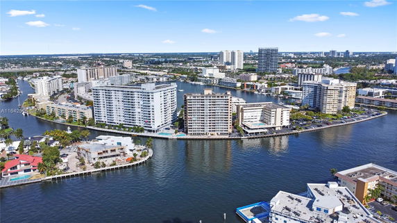 Aerial view of a waterfront area with high-rise buildings.