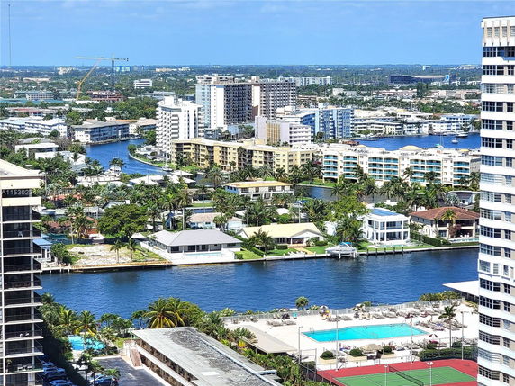 Panoramic view of a cityscape featuring various residential high-rise buildings and a river.