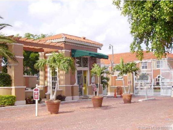 Front view of a building with a gated entrance and tile roofing.