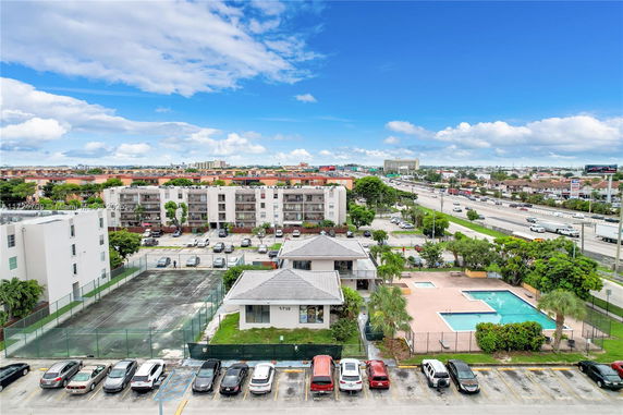 Aerial view of a residential area with several apartment buildings and a swimming pool.