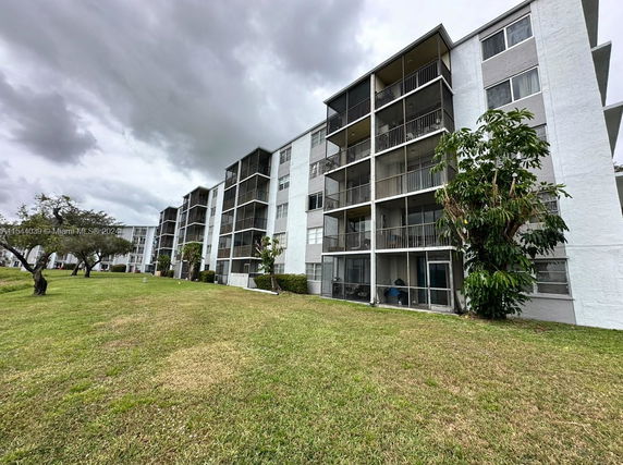 Exterior view of a multi-story apartment building with balconies.