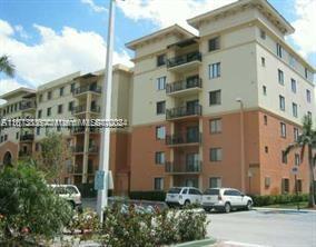 Front view of a multi-story apartment building with balconies.