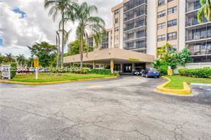 Front view of a multi-story residential building with a covered entrance.
