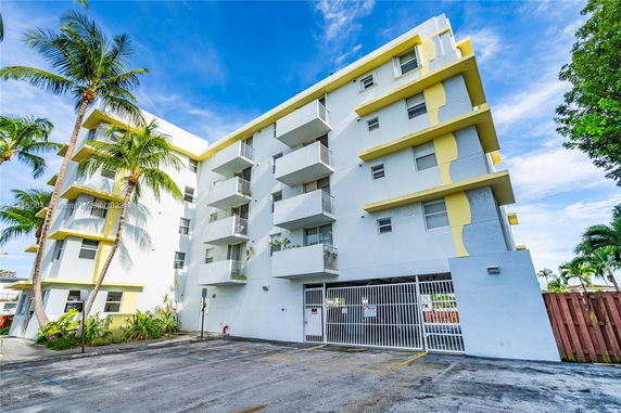Front view of a multi-story residential building with balconies.