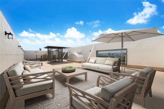 Rooftop with outdoor seating area, umbrellas, and seating arrangements.