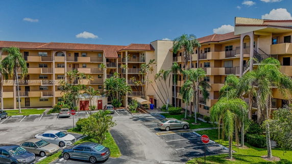 Front view of a multi-story apartment building with balconies.