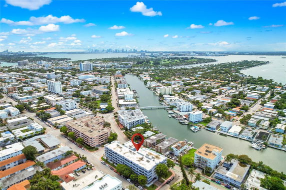 Aerial view of a coastal urban area with multiple residential buildings and waterways.
