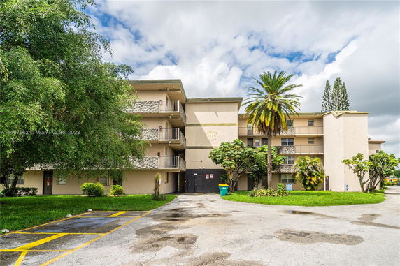 Front view of a multi-story residential building with balconies.