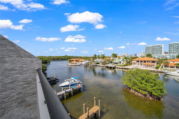 Panoramic view of waterfront properties with boats and a waterway.