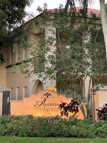 Front view of a two-story building with a sign reading 'Aventine at Miramar'.