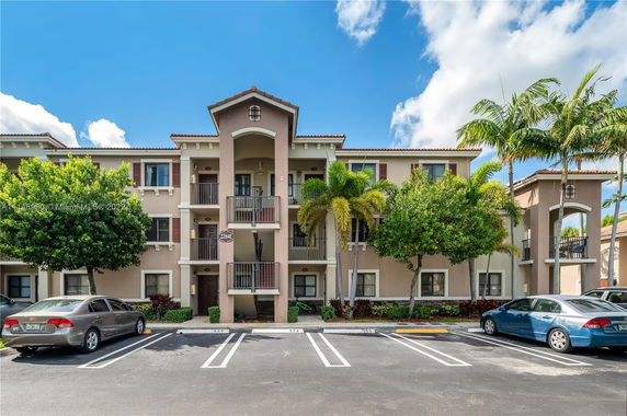 Front view of a multi-story apartment building with balconies.