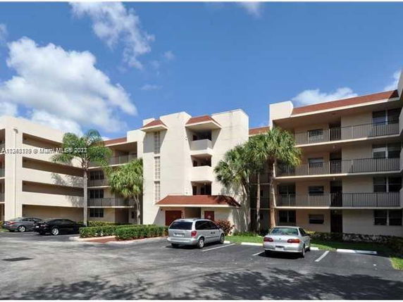 Front view of a multi-story residential building with balconies.