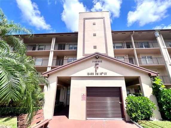 Front view of a multi-story residential building with balconies.