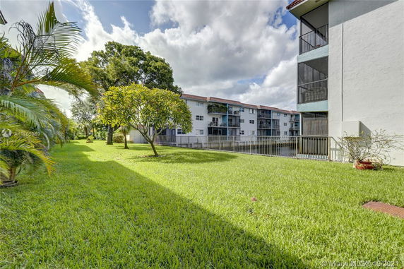 View of surrounding buildings and grassy area with trees.