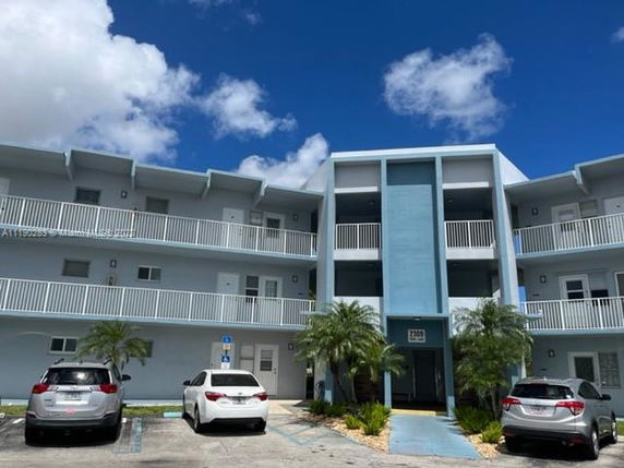 Front view of a three-story residential building with balconies.