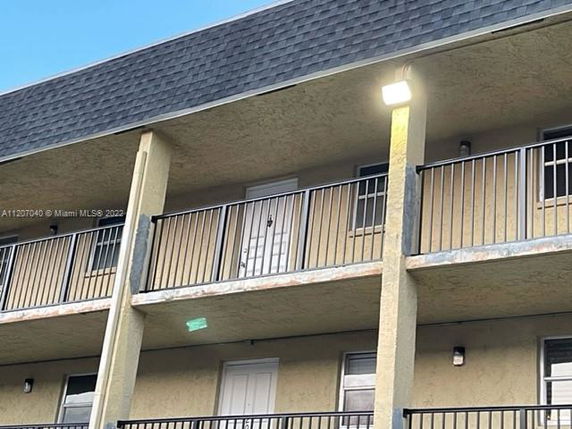 Front view of a multi-story building with balconies.