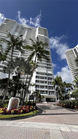 Front view of a high-rise residential building with balconies.
